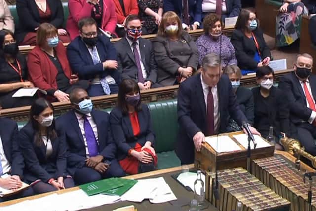 A view of Bury South MP Christian Wakeford (centre back, in Union Flag mask) sitting on the opposition benches as Labour leader Keir Starmer speaks during Prime Minister’s Questions (image: PA)