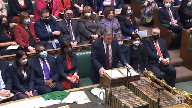 A view of Bury South MP Christian Wakeford (centre back, in Union Flag mask) sitting on the opposition benches as Labour leader Keir Starmer speaks during Prime Minister’s Questions (image: PA)