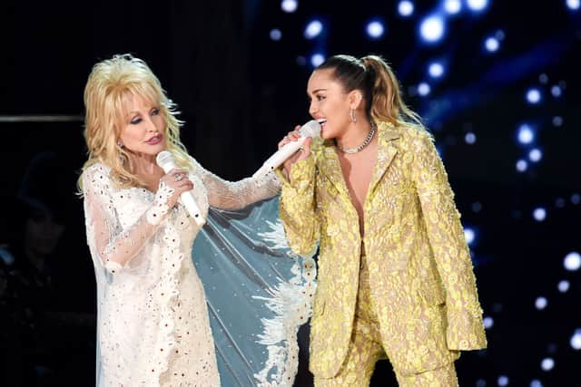 Dolly Parton and her goddaughter Miley Cyrus performing onstage during the 61st Annual GRAMMY Awards (Photo: Kevin Winter/Getty Images for The Recording Academy)