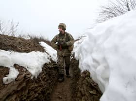 A Ukrainian Military Forces serviceman walks on a trench on the frontline with Russia-backed separatists near Luganske village, in Donetsk region (Photo: ANATOLII STEPANOV/AFP via Getty Images)