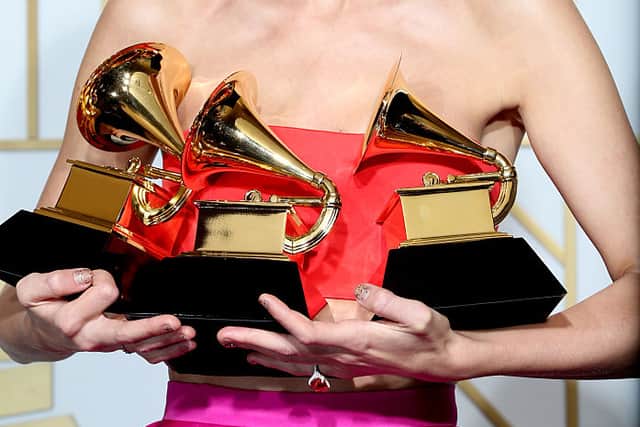 Taylor Swift posing as the winner of the awards for Album of the Year and Best Pop Album at The 58th GRAMMY Awards (Photo: Frederick M. Brown/Getty Images)