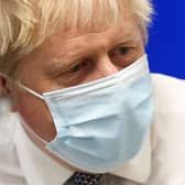 Boris Johnson, wearing a face covering to help mitigate the spread of Covid-19, reacts during his visit to Milton Keynes University Hospital (Photo by Adrian Dennis - WPA Pool/Getty Images)
