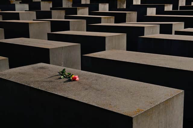 A single rose has been placed on a concrete block at the Holocaust Memorial in Berlin (Photo: TOBIAS SCHWARZ/AFP via Getty Images)