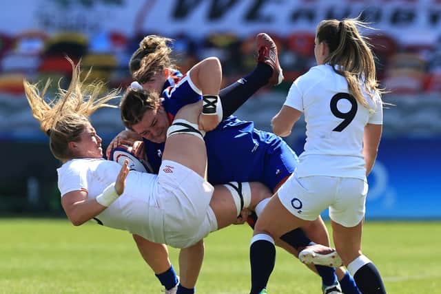 Poppy Cleall of England is tackled by Rose Bernadou during the Women's Six Nations match between England and France at Twickenham Stoop on April 24, 2021