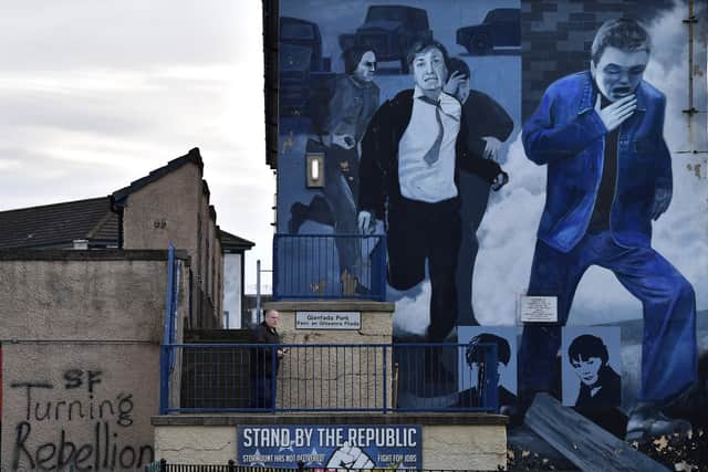 A man walks past a mural at Free Derry corner (Photo: Getty)