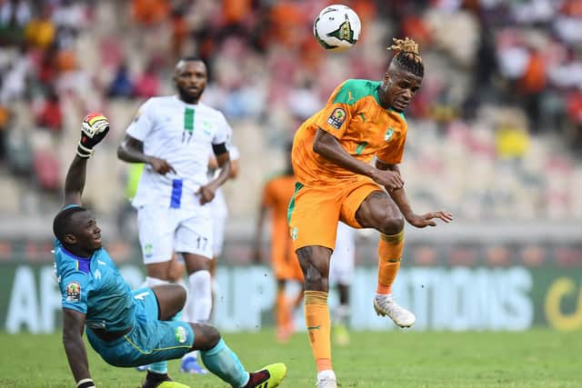 Wilfred Zaha (R) makes an unsuccessful attempt at goal as Sierra Leone's goalkeeper  (Photo by CHARLY TRIBALLEAU / AFP) (Photo by CHARLY TRIBALLEAU/AFP via Getty Images)