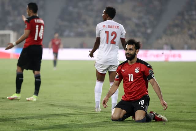 Mohamed Salah (R) celebrates next to Sudan’s midfielder Mustafa Ahmed Saeed (Photo by KENZO TRIBOUILLARD/AFP via Getty Images)