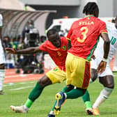  Naby Keita (L) and Guinea’s defender Issiaga Sylla fight for the ball wtih Senegal (Photo by PIUS UTOMI EKPEI/AFP via Getty Images)