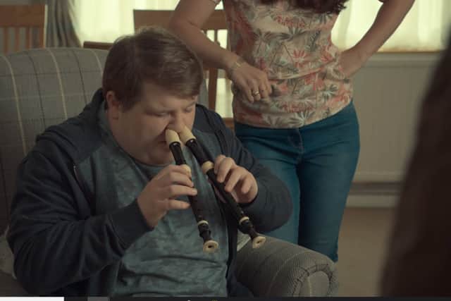 Ethan attempts playing two recorders with his nose in After Life (Photo: Netflix)