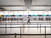 A passenger walks past the deserted check-in desks and passenger facilities in the North Terminal at Gatwick Airport on November 27, 2020 in London (Getty Images)