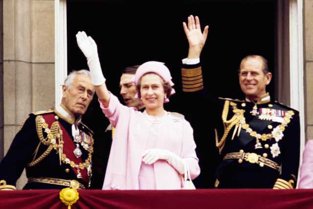 From left, Earl Mountbatten of Burma, Queen Elizabeth II and the Duke of Edinburgh waving from the balcony of Buckingham Palace after the Silver Jubilee procession (Photo: PA)