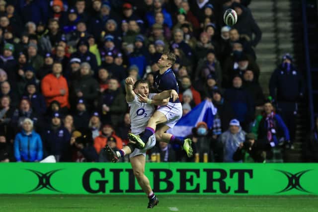 Luke Cowan-Dickie of England throws the ball into touch under pressure from  Darcy Graham of Scotland, resulting in a penalty try. (Photo by David Rogers/Getty Images)
