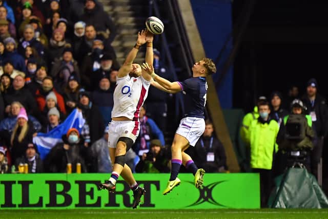 England's hooker Luke Cowan-Dickie (L) receives a yellow card and Scotland get a penalty try for putting the ball out to touch as he challenges with Scotland's wing Darcy Graham (R) during the Six Nations international rugby union match between Scotland and England at Murrayfield Stadium in Edinburgh, Scotland on February 5, 2022