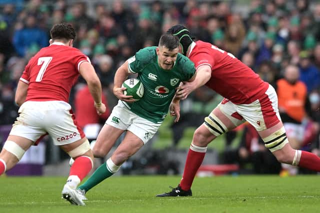 Johnny Sexton of Ireland is tackled by Adam Beard of Wales (R) during the Guinness Six Nations match between Ireland and Wales at Aviva Stadium on February 05, 2022 in Dublin, Ireland