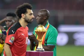 Egypt's forward Mohamed Salah walks past the trophy after loosing the Africa Cup of Nations (CAN) 2021 final football match between Senegal and Egypt at Stade d'Olembe in Yaounde on February 6, 2022