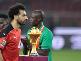 Egypt's forward Mohamed Salah walks past the trophy after loosing the Africa Cup of Nations (CAN) 2021 final football match between Senegal and Egypt at Stade d'Olembe in Yaounde on February 6, 2022