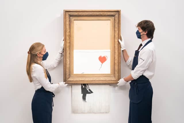 Banksy shocked the art world with Love is in the Bin - an art piece that shredded itself after being auctioned off (image: PA)