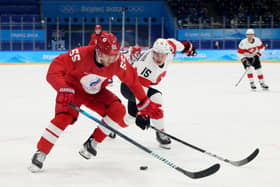  Vladimir Tkachyov #55 of Team ROC challenges Gregory Hofmann #15 of Team Switzerland in the first period during the Men’s Preliminary Round Group B match on Day 5 of the Beijing 2022 Winter Olympic Games at National Indoor Stadium on February 09, 2022 in Beijing, China