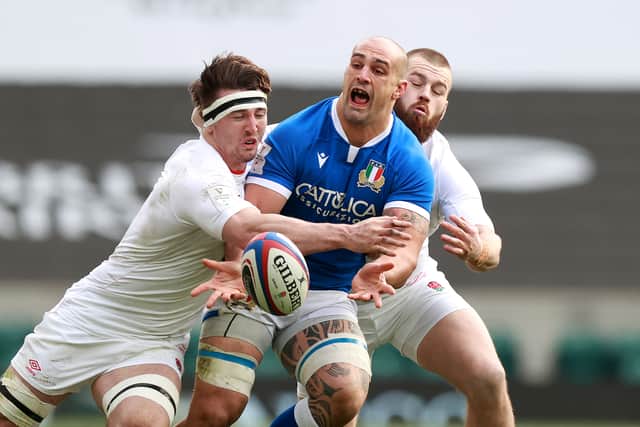 Marco Lazzaroni of Italy is tackled by Tom Curry (L) and Luke Cowan-Dickie during the Guinness Six Nations match between England and Italy at Twickenham Stadium on February 13, 2021 in London