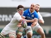 Marco Lazzaroni of Italy is tackled by Tom Curry (L) and Luke Cowan-Dickie during the Guinness Six Nations match between England and Italy at Twickenham Stadium on February 13, 2021 in London