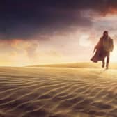 Obi-Wan Kenobi walks across what are presumably the desert dunes of Tatooine in Star Wars spin-off series of the same name (Image: Disney)
