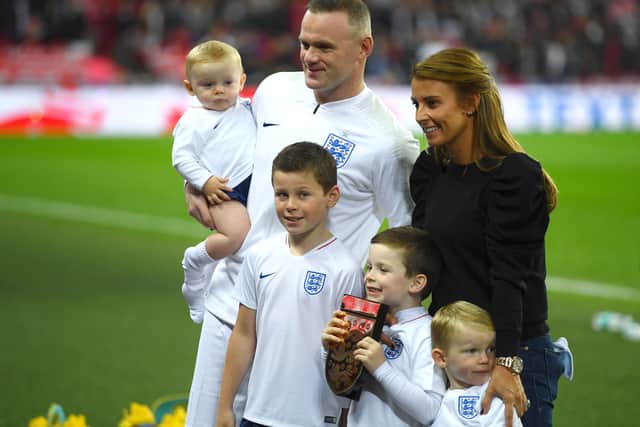 Wayne Rooney, Coleen and their children Kit Joseph, Klay Anthony, Kai and Cass Mac pose for a photo pitside prior to the International Friendly match between England and United States  on November 15 (Photo by Mike Hewitt/Getty Images)