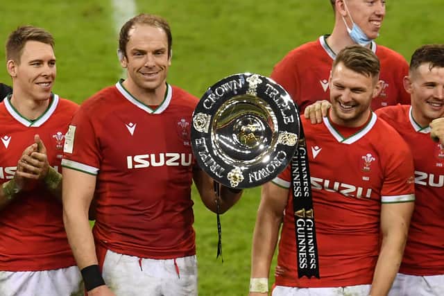 Wales' lock Alun Wyn Jones (C) holds the triple crown trophy as Wales celebrate after the Six Nations international rugby union match between Wales and England at the Principality Stadium in Cardiff, south Wales, on February 27, 2021