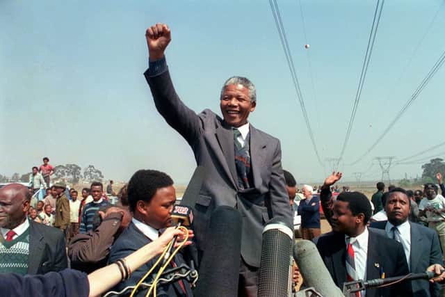 Anti-apartheid leader and African National Congress (ANC) member Nelson Mandela raises his fist in Tokoza (Photo: TREVOR SAMSON/AFP via Getty Images)
