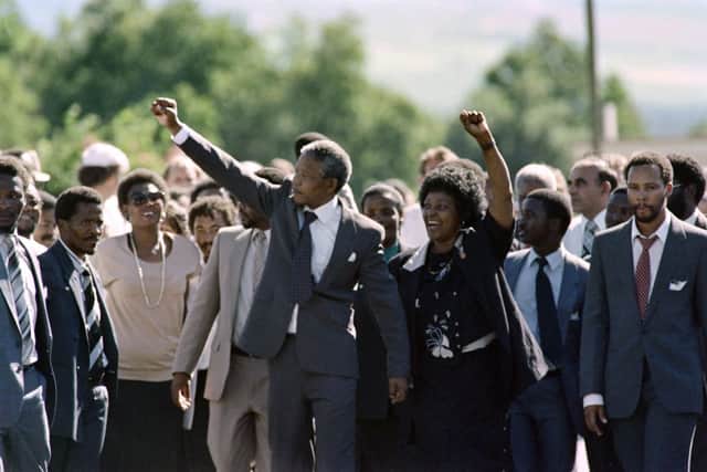 Nelson Mandela and his wife anti-apartheid campaigner Winnie raise fists upon Mandela’s release from Victor Verster prison on February 11, 1990 (Photo: ALEXANDER JOE/AFP via Getty Images)