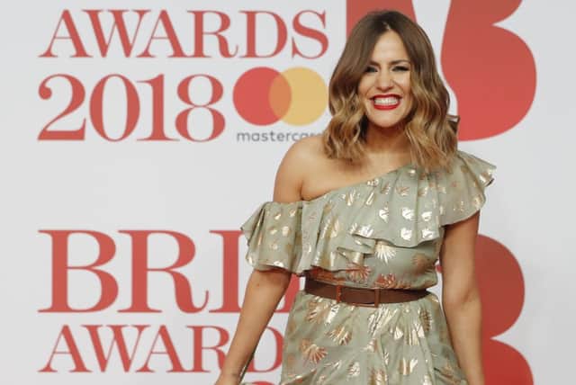 British television presenter Caroline Flack poses on the red carpet on arrival for the BRIT Awards 2018 (Photo: TOLGA AKMEN/AFP via Getty Images)