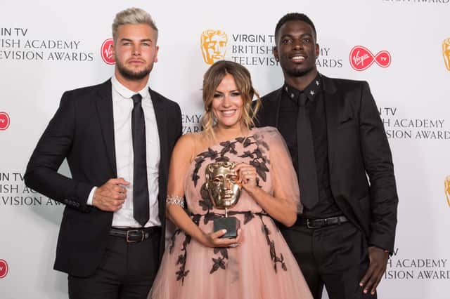 Caroline Flack with Love Island stars Chris Hughe and Marcel Somerville as they pose with the award for Best Reality and Constructed Factual Series for Love Island (Photo: Jeff Spicer/Getty Images)