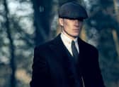 Cillian Murphy as Tommy Shelby, his distinctive flat cap casting a shadow over his face (Credit: BBC/Caryn Mandabach Productions Ltd./Robert Viglasky)