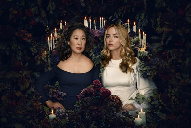 Sandra Oh and Jodie Comer in a promotional image for Killing Eve S4, surrounded by flowers (Credit: BBC)