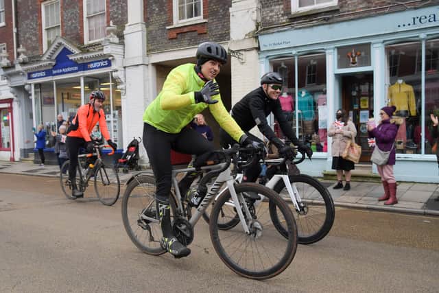 Tom Daley cycles through Blandford town centre. 