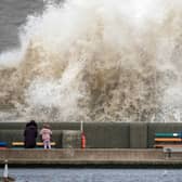 People view the waves created by high winds and spring tides hitting the sea wall at New Brighton promenade in Liverpool (Photo: Christopher Furlong/Getty Images)
