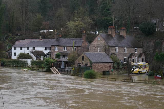 The waters of the River Severn edge towards homes in Ironbridge (Photo: PA)
