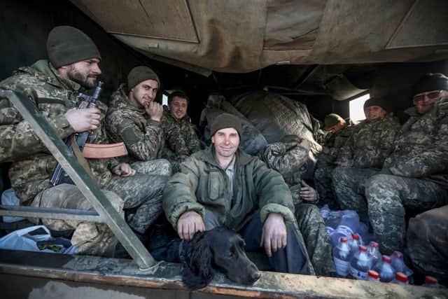 Ukraine’s Military Forces servicemen sit in the back of military truck in the Donetsk region town of Avdiivka, on the eastern Ukraine front-line with Russia-backed separatists on 21 February (Photo: ALEKSEY FILIPPOV/AFP via Getty Images)
