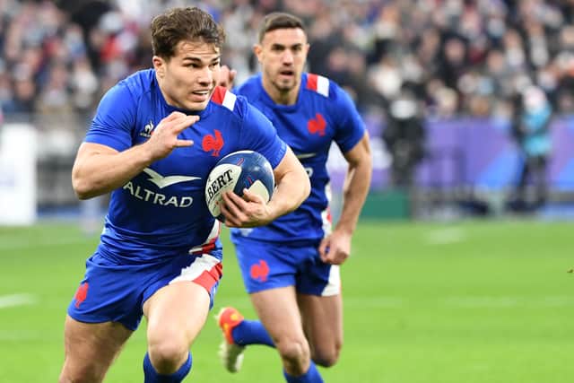 France's scrum-half and captain Antoine Dupont runs with the ball during the Six Nations rugby union international match between France and Ireland at the Stade de France, in Saint-Denis, north of Paris, on February 12, 2022