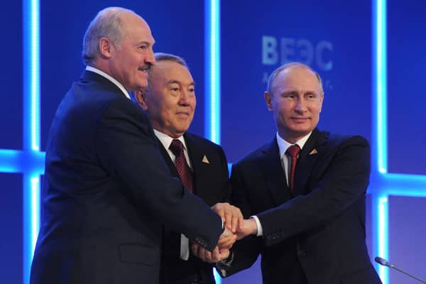 Vladimir Putin shakes hands with his Kazakh counterpart Nursultan Nazarbayev, and Belarussian counterpart Alexander Lukashenko during a meeting of the Eurasian Economic Union in 2014 (Photo: MIKHAIL KLIMENTYEV/RIA NOVOSTI POOL/AFP via Getty Images)