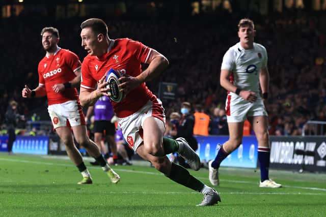 Josh Adams breaks away to score their first try during the Guinness Six Nations Rugby match between England and Wales at Twickenham Stadium on February 26, 2022 in London, England
