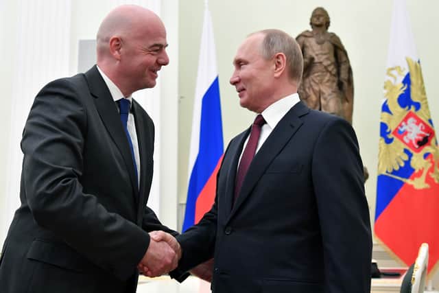 Russian President Vladimir Putin shakes hands with FIFA President Gianni Infantino during a meeting at the Kremlin in 2019