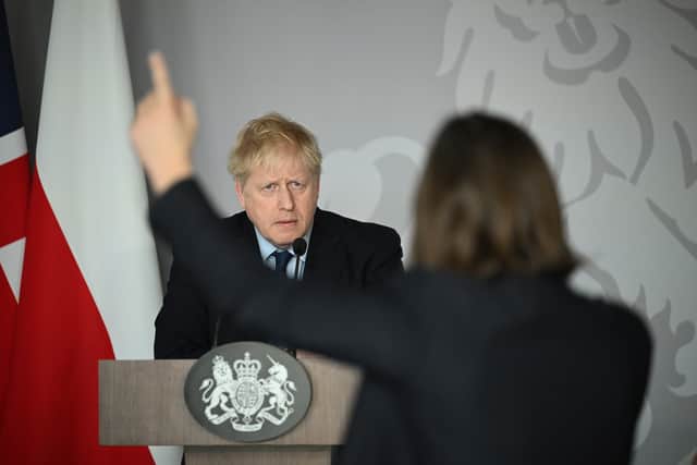 Prime Minister Boris Johnson takes a question from  Daria Kaleniuk during a press conference at the British Embassy in Warsaw.