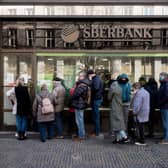 People queue outside a branch of Russian state-owned bank Sberbank to withdraw their savings and close their account (Photo: MICHAL CIZEK/AFP via Getty Images)