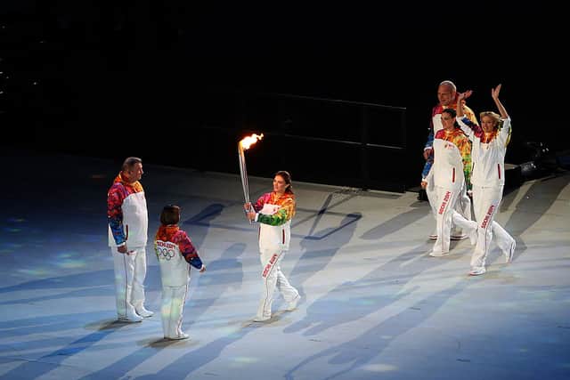 Alina Kabaeva carries the Olympic torch to Vladislav Tretyak and Irina Rodina during the Opening Ceremony of the Sochi 2014 Winter Olympics (Photo: Bruce Bennett/Getty Images)