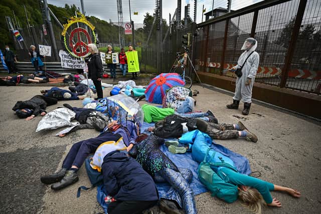 CND activists hold a die-in protest at the North Gate of Her Majesty’s Naval Base, Clyde on September 26, 2021 in Faslane (Photo by Jeff J Mitchell/Getty Images)