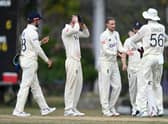 Joe Root of England celebrates with teammates after dismissing Shamar Springer of West Indies. 