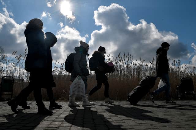 People crossing the Ukrainian border into Poland, at Medyka border crossing. The UN says at least 2.2 million people have fled Ukraine, It has called the exodus Europe’s fastest-growing refugee crisis since World War II.
