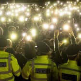 People in the crowd turning on their phone torches in Clapham Common, London, for a vigil for Sarah Everard (PA)