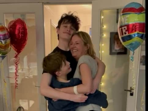 Nicola Sharpe was embraced by her boys Finley and Rory when she arrived back home (Photo: Royal Papworth Hospital / SWNS)
