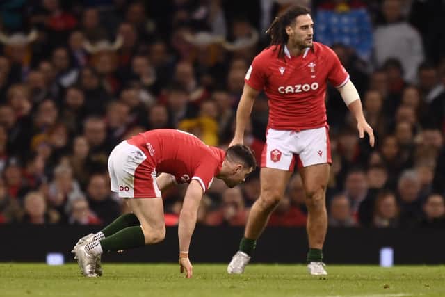 Tomos Williams of Wales struggles with a head injury as he's determined to continue during the Guinness Six Nations Rugby match between Wales and France at Principality Stadium on March 11